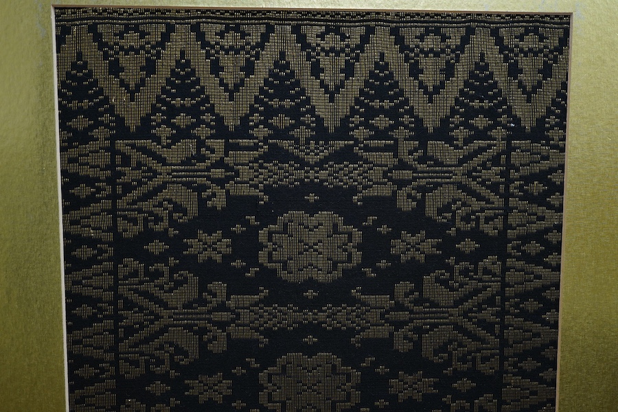 A framed 20th century black and gold brocade sample, possibly Thai 37cm x 97cm.